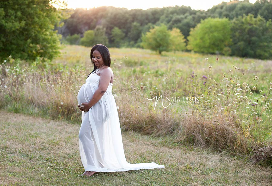 Beautiful white maternity gown on pregnant mother outdoor maternity session