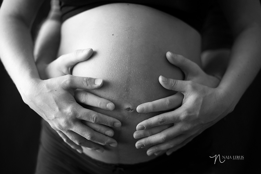 hands on belly mother father expecting new baby maternity photos chicago