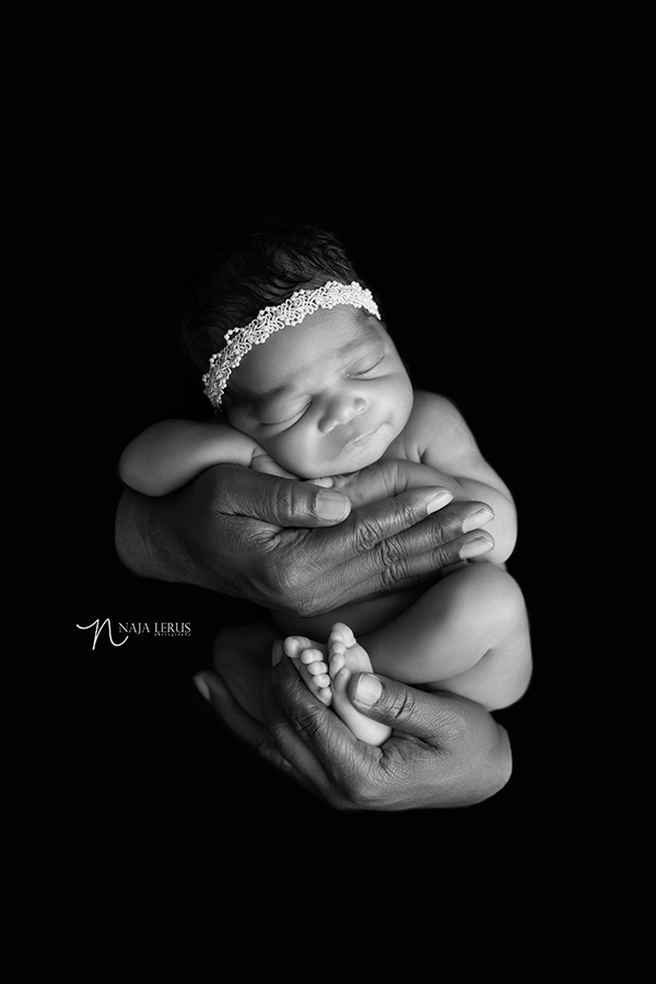 baby in father's hands black in white