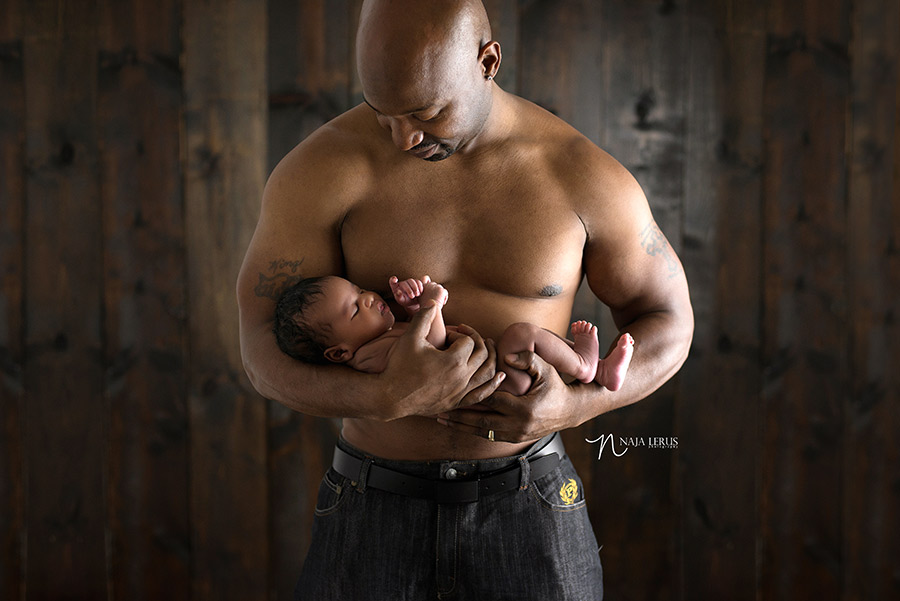 shirtless father withe newborn son photoshoot