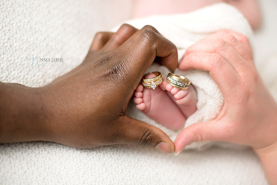 newborn feet in parents hands shaped in heart chicago IL